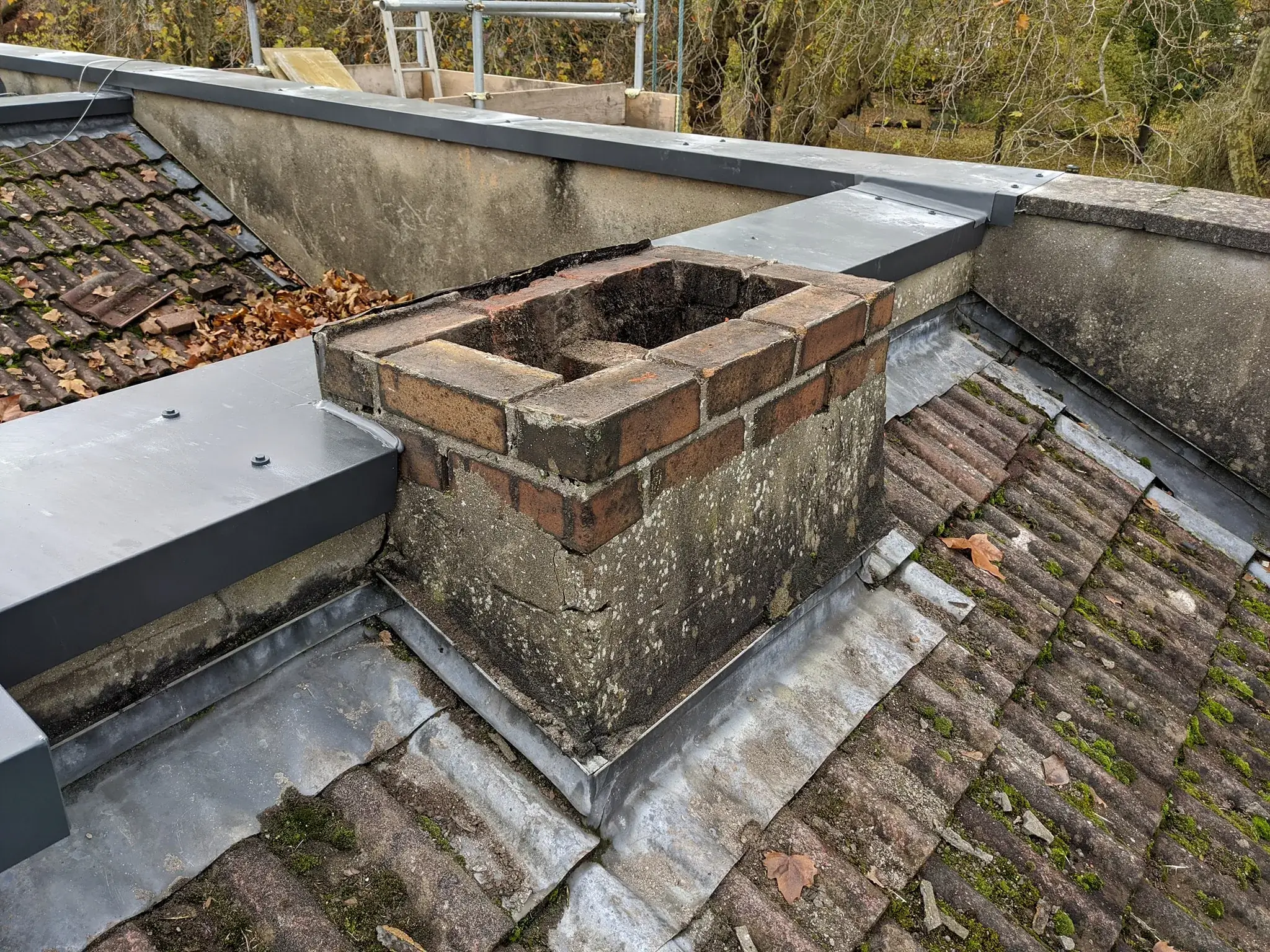 A brick chimney on the roof of a building.