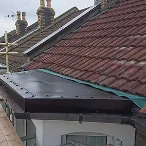 The roof of a building with a chimney on it.