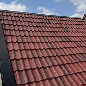 A red tiled roof with a sky background.