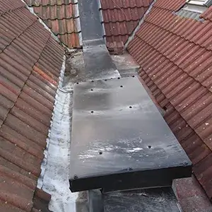 A black bench sitting on top of a roof.