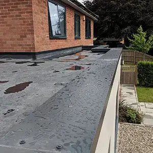 A flat roof with rain drops on it.
