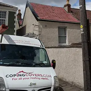 A white van parked in front of a house.