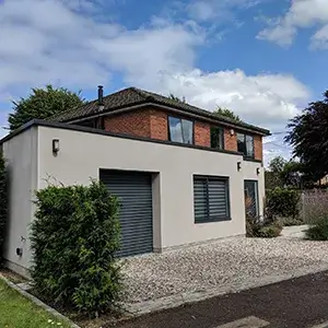 A house with a driveway and a car parked in front of it.